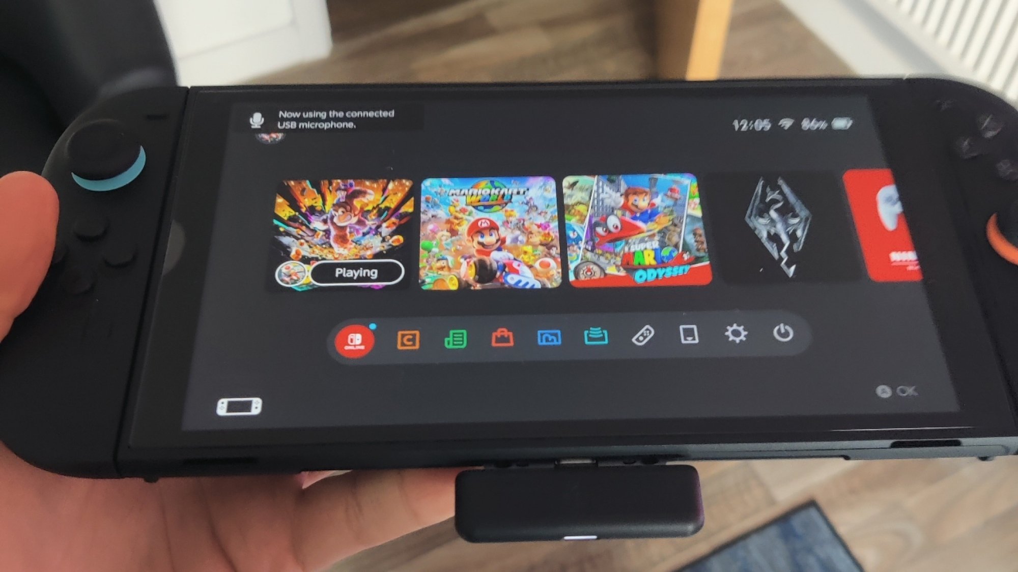 The Steelseries Arctis Nova 7x Headset Dongle Digug dari Nintendo Switch 2