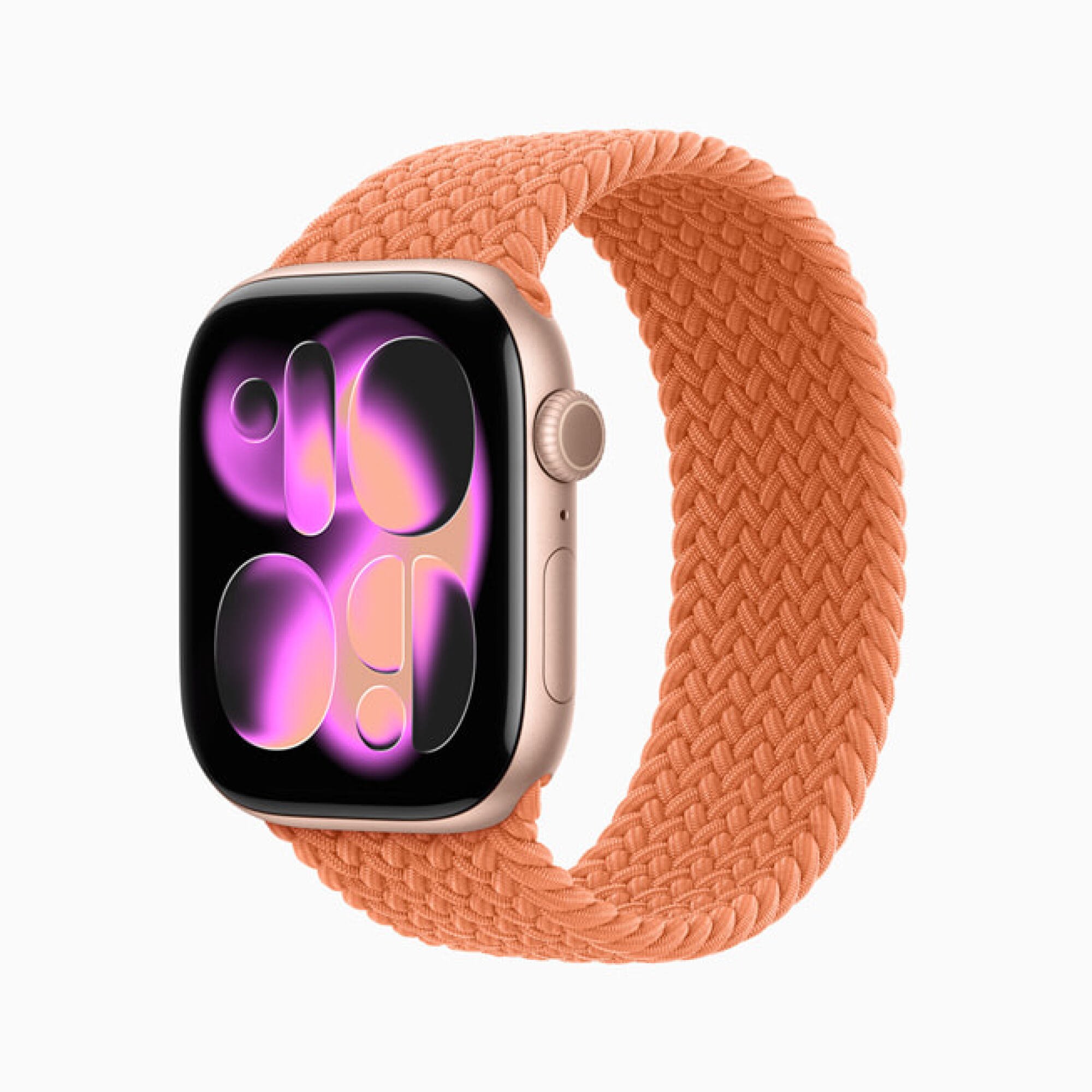 Apple Watch dengan gelang oranye yang menunjukkan opsi Watch Face baru yang menggabungkan gelembung transparan
